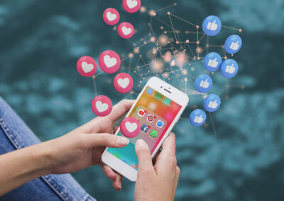 Ragazzo con in mano il cellulare dove si vedono le icone social